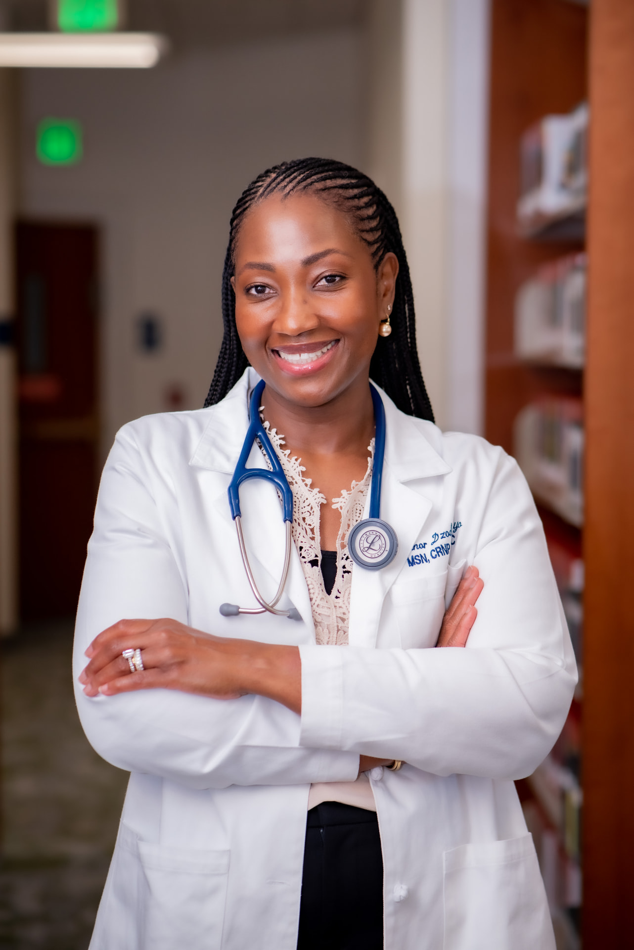 Your BrightPath Health provider, smiling with arms crossed in a clinic hallway